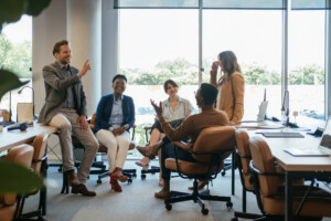 Group of Smiling Businesspeople in a Casual Meeting at their Company