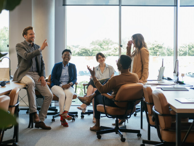 Group of Smiling Businesspeople in a Casual Meeting at their Company