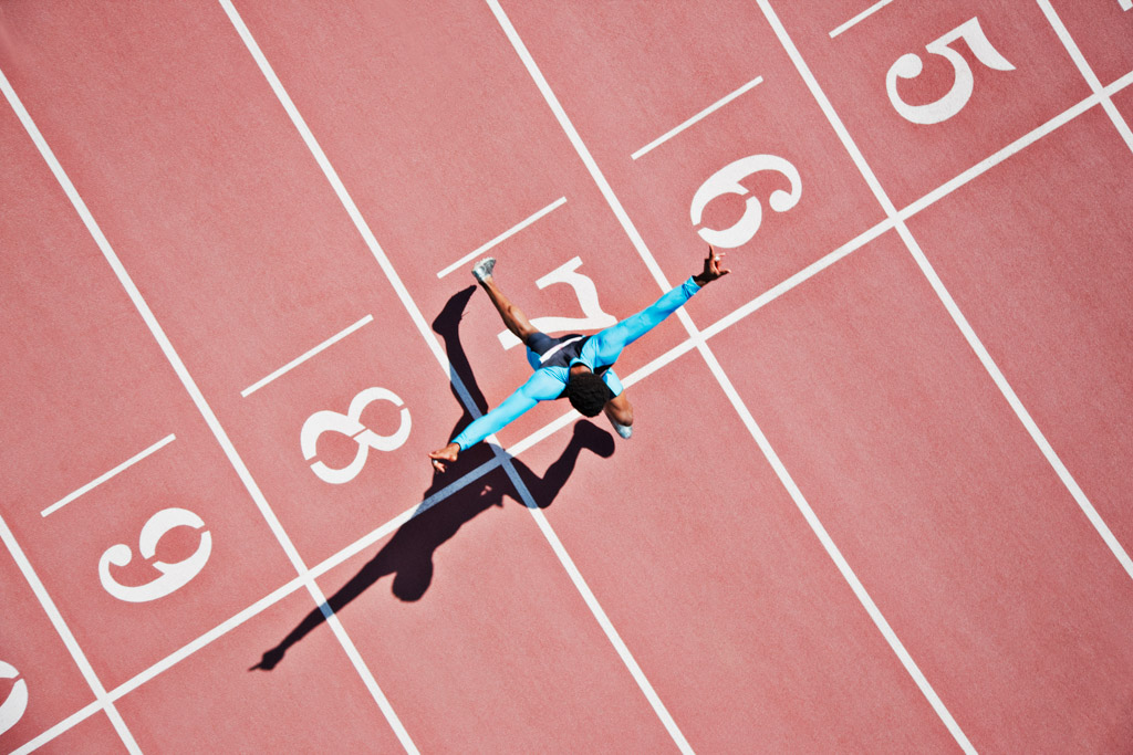 Runner crossing finishing line on track