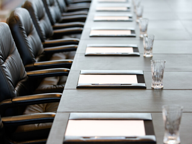 The boardroom table is set for a meeting