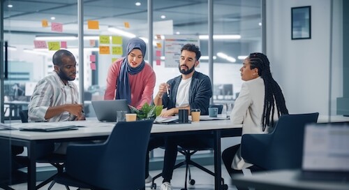 Team of four at a table sharing insights
